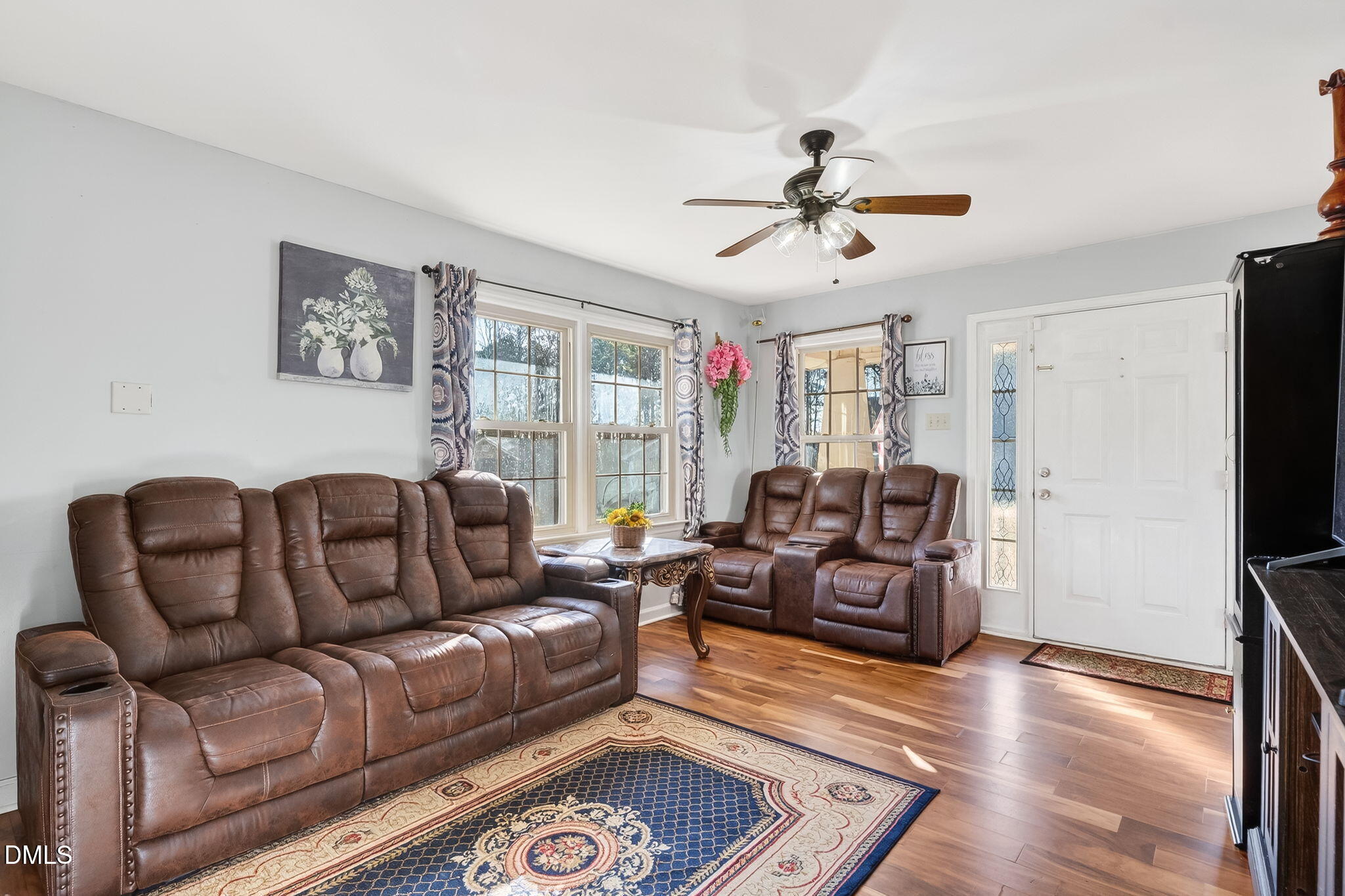 6201 Barrington Village Lane Raleigh, NC 27610 - Photo 6 of 25 a living room with furniture ceiling fan and a wooden floor