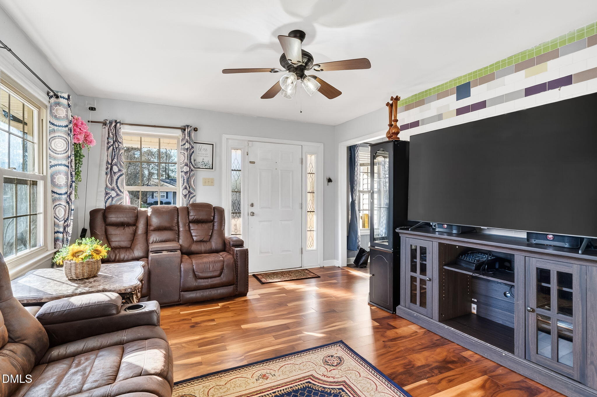 6201 Barrington Village Lane Raleigh, NC 27610 - Photo 8 of 25 a living room with furniture and a flat screen tv