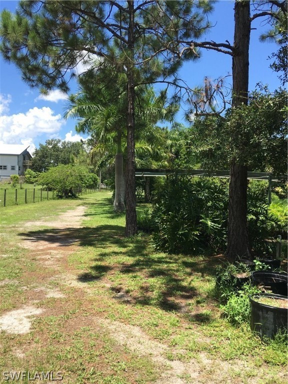 11731 Shawnee Road Fort Myers, FL 33913 - Photo 13 of 20 a view of a yard with a house