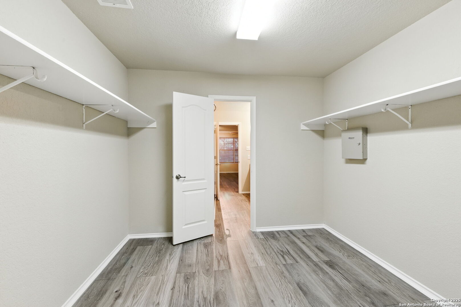 506 Leafy Ridge San Antonio, TX 78251 - Photo 20 of 48 a view of an empty room with wooden floor and a window