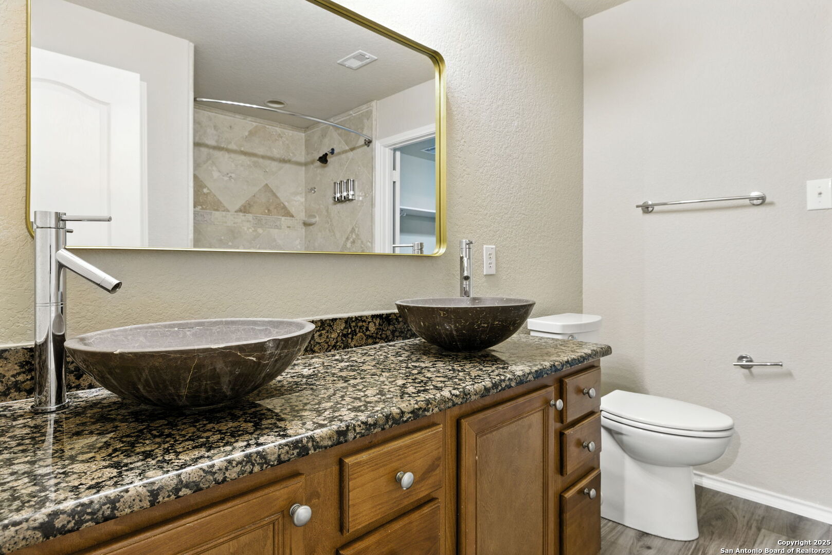 506 Leafy Ridge San Antonio, TX 78251 - Photo 21 of 48 a bathroom with a granite countertop toilet sink and mirror