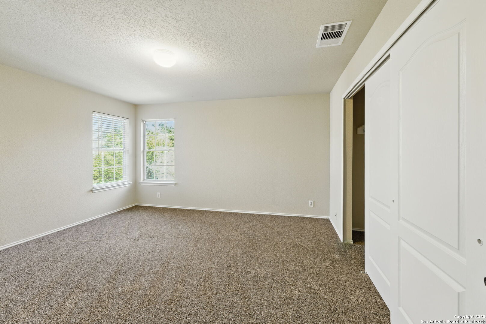 506 Leafy Ridge San Antonio, TX 78251 - Photo 36 of 48 an empty room with windows and closet