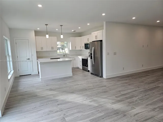 a view of kitchen with wooden floor