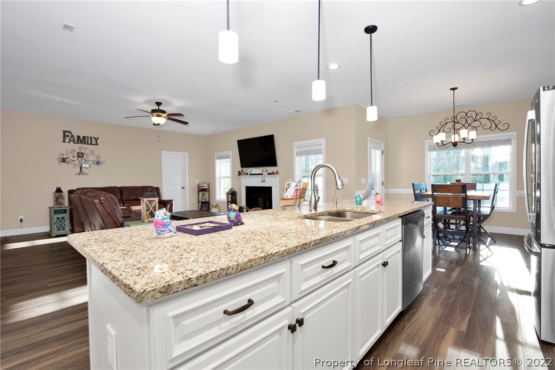2624 Riddle Farm Road Hope Mills, NC 28348 - Photo 13 of 33 a view of a kitchen counter top space a sink appliances and wooden floor