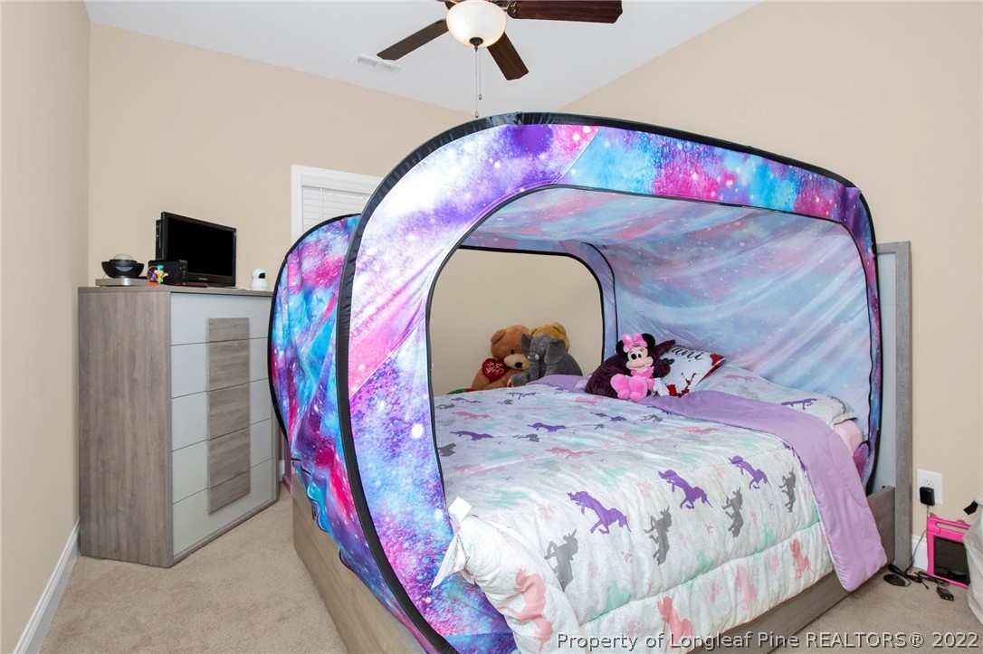 2624 Riddle Farm Road Hope Mills, NC 28348 - Photo 20 of 33 a bedroom with a bed and a flat screen tv