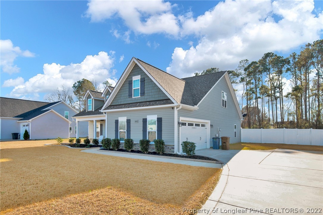 2624 Riddle Farm Road Hope Mills, NC 28348 - Photo 2 of 33 a front view of a house with a yard and potted plants