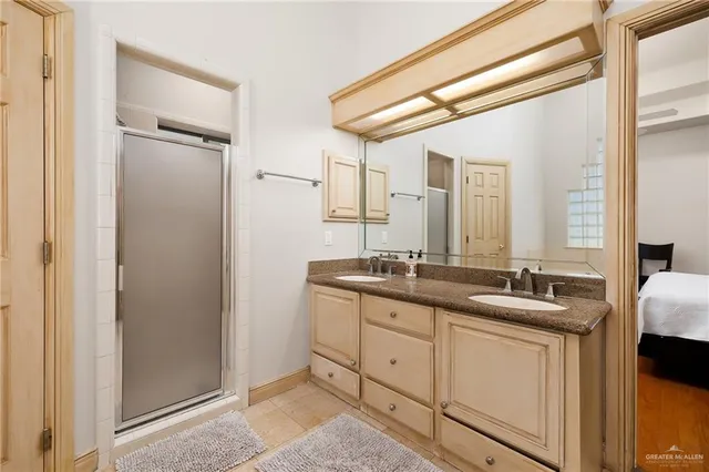 a bathroom with double sink and a mirror