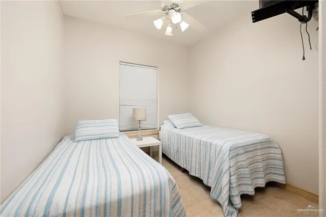 a bedroom with two beds and a chandelier