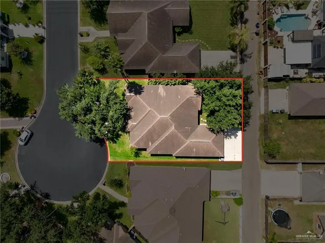 an aerial view of a house with yard swimming pool and outdoor seating
