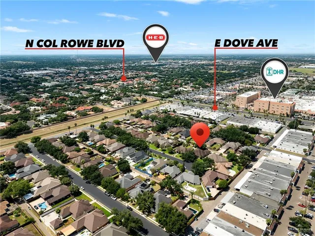 an aerial view of a house with a yard and tennis court