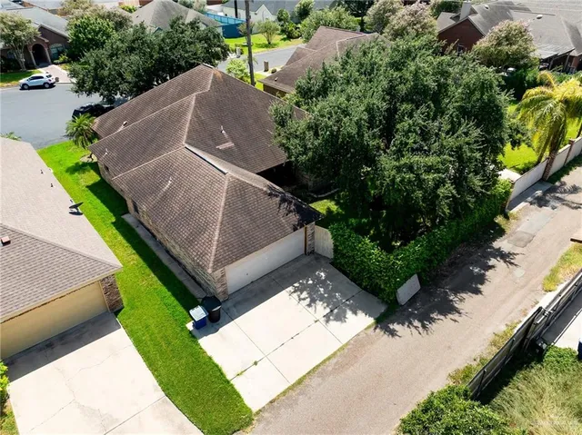 an aerial view of a house with garden space and street view