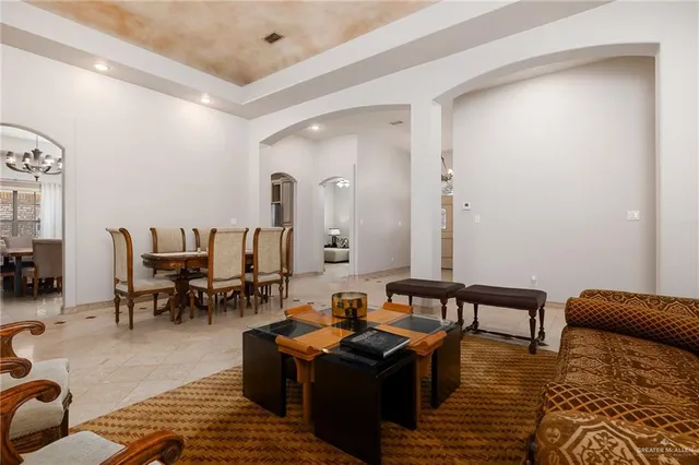 a living room with furniture and a dining table