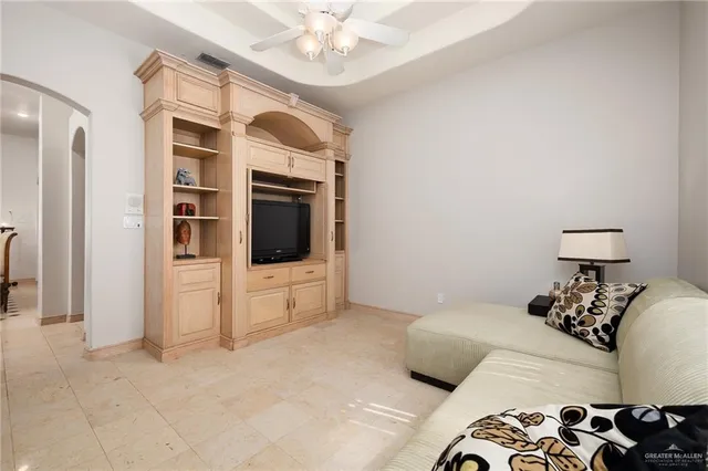 a bedroom with a bed and a television