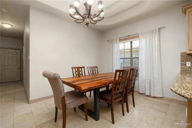 a view of a dining room with furniture and chandelier