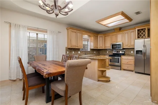 a dining room with furniture a window and kitchen view