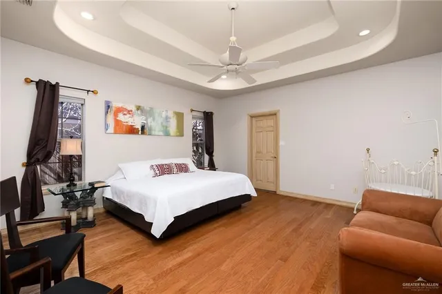 a spacious bedroom with a bed and a couch