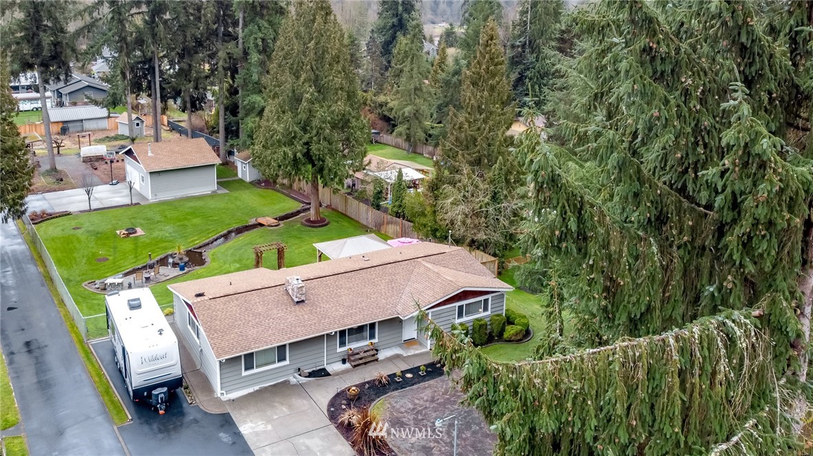 17021 Southeast Jones Road Renton, WA 98058 - Photo 1 of 27 a view of a patio with table and chairs potted plants and large tree