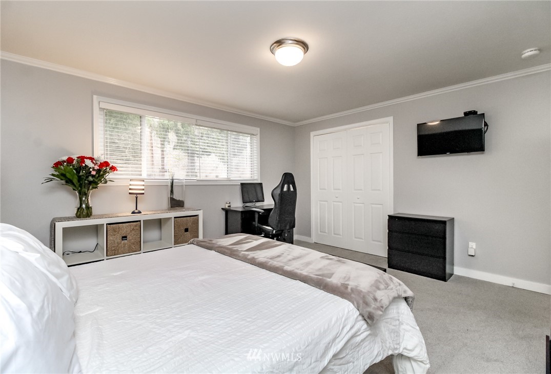 17021 Southeast Jones Road Renton, WA 98058 - Photo 12 of 27 a bedroom with a bed and a flat screen tv