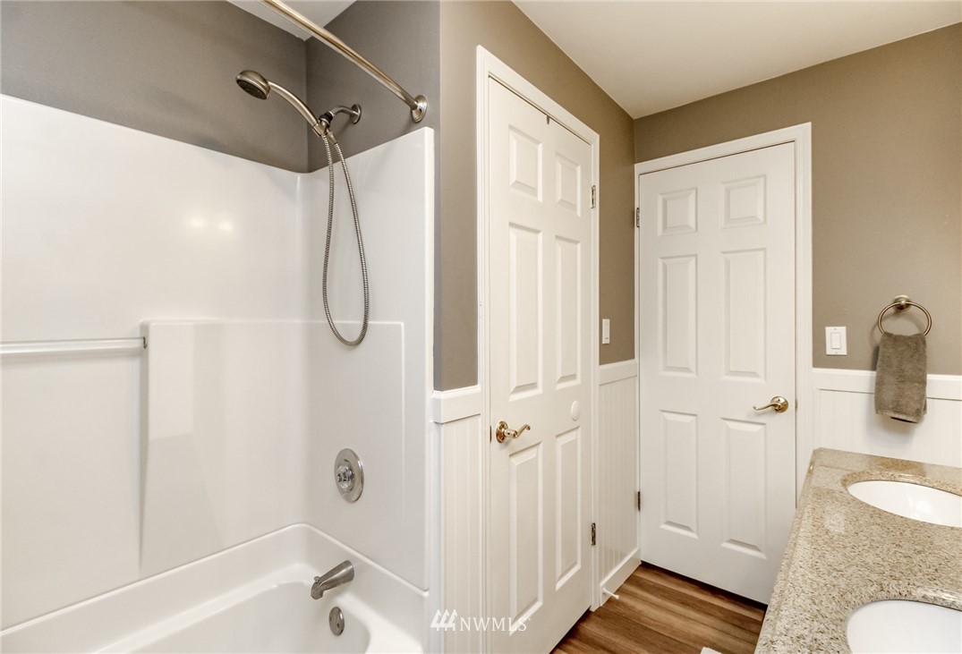 17021 Southeast Jones Road Renton, WA 98058 - Photo 15 of 27 a bathroom with a granite countertop shower and a sink