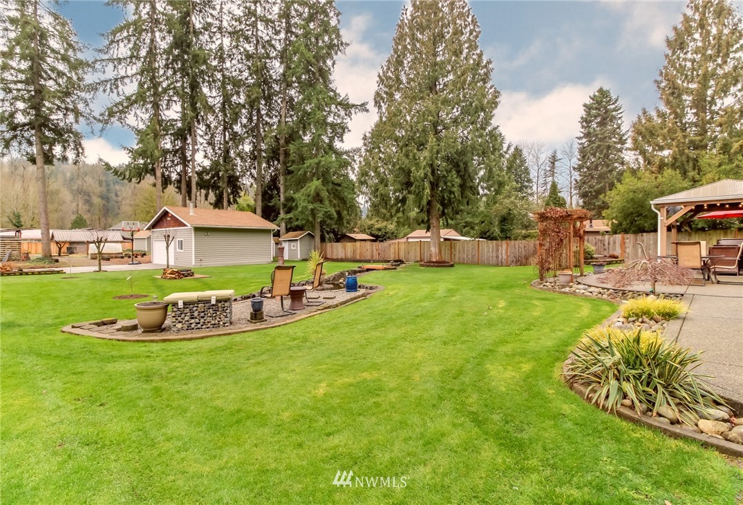 17021 Southeast Jones Road Renton, WA 98058 - Photo 16 of 27 a view of a house with a big yard and sitting area