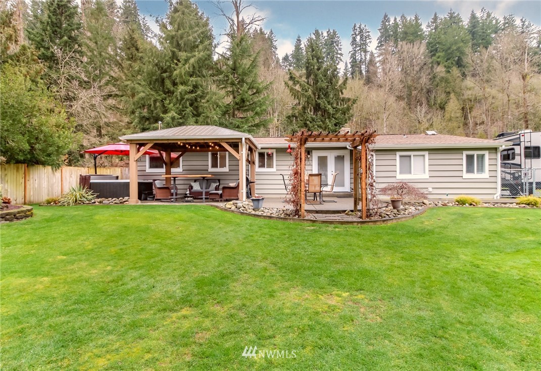 17021 Southeast Jones Road Renton, WA 98058 - Photo 25 of 27 a front view of a house with a garden and trees