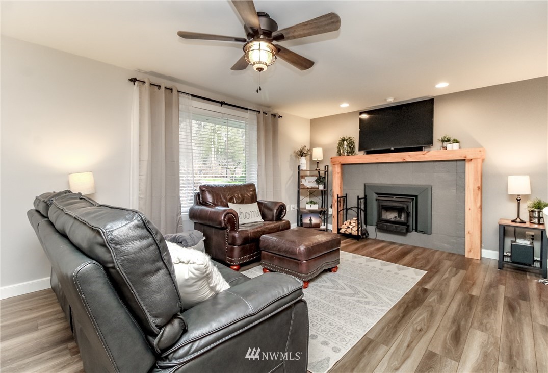 17021 Southeast Jones Road Renton, WA 98058 - Photo 3 of 27 a living room with furniture and a fireplace