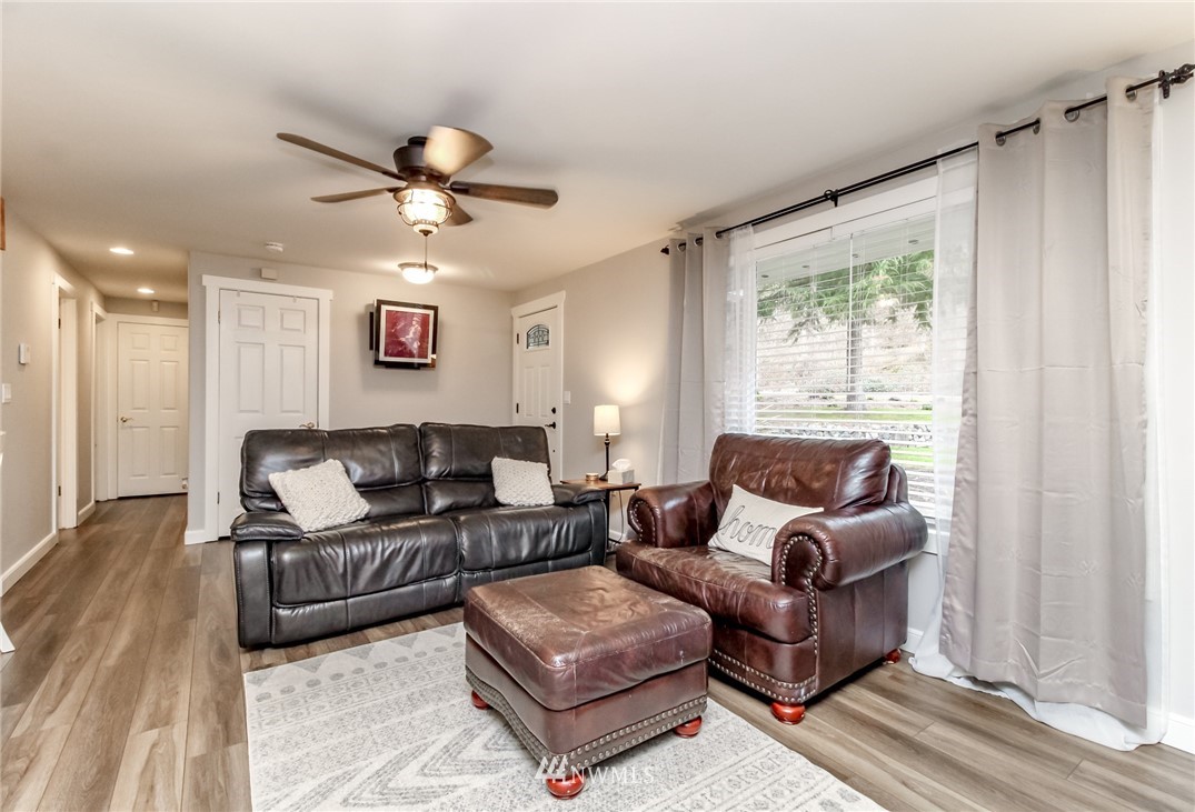 17021 Southeast Jones Road Renton, WA 98058 - Photo 4 of 27 a living room with furniture and a large window