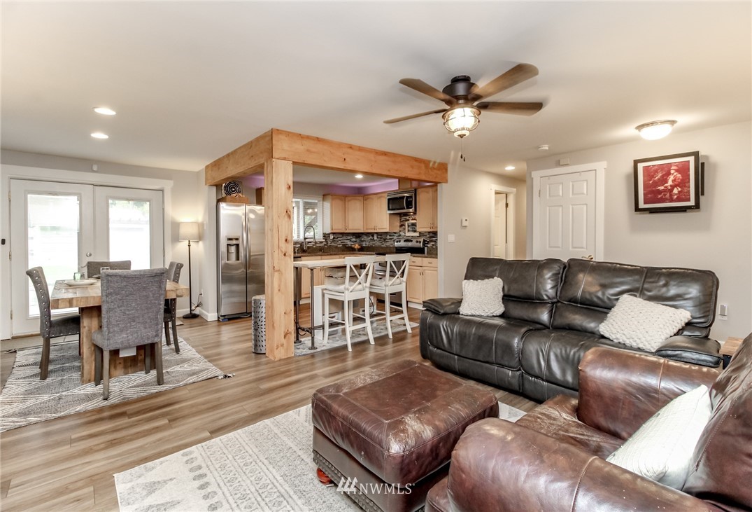 17021 Southeast Jones Road Renton, WA 98058 - Photo 5 of 27 a view of a livingroom with furniture and a ceiling fan