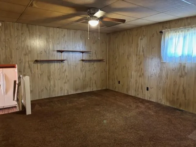 a view of an empty room with a ceiling fan