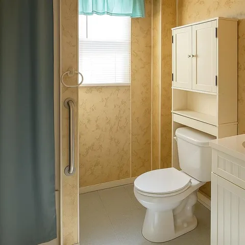 a white toilet sitting next to a bathroom sink