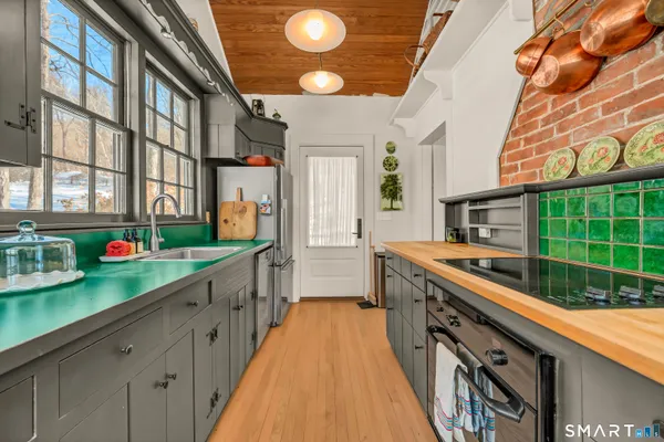 a large kitchen with stainless steel appliances granite countertop a lot of counter space and a large window