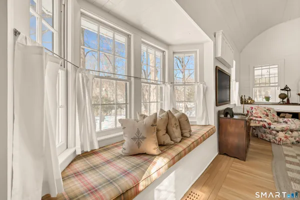 a living room with furniture and large windows