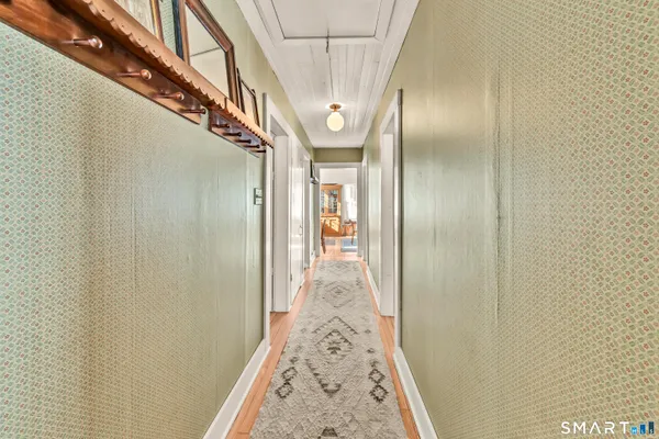 a view of hallway with wooden floor