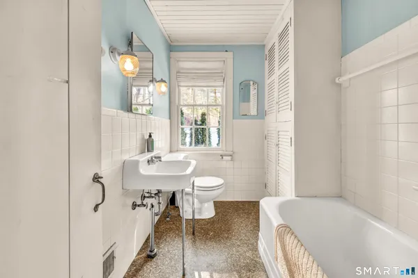 a bathroom with a sink toilet tub and shower