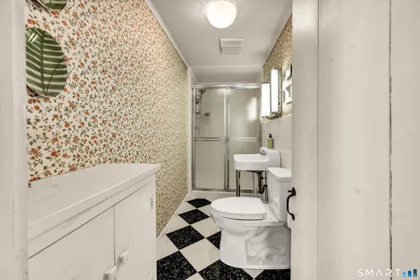a bathroom with a sink toilet and shower