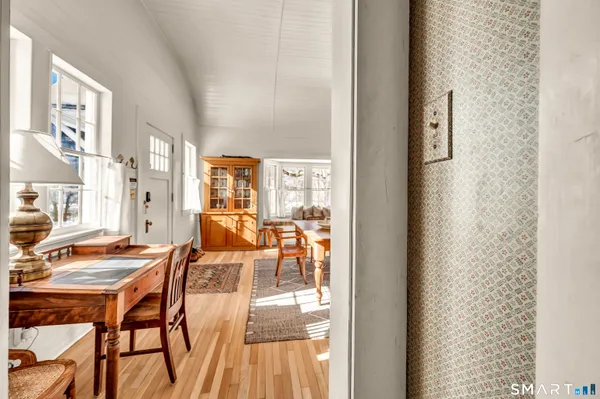 a view of a dining room with furniture and wooden floor