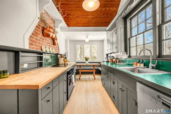 a kitchen with counter top space and windows