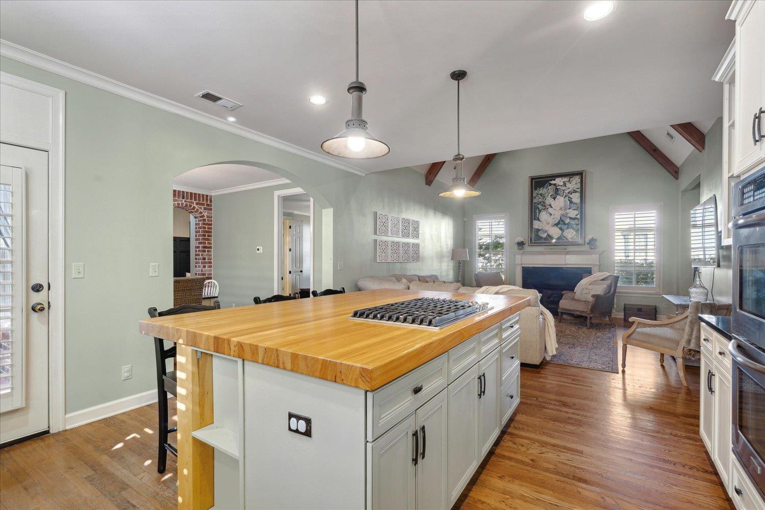 307 Colbert Street West Collierville, TN 38017 - Photo 13 of 34 Kitchen featuring white cabinets, vaulted ceiling with beams, a center island, and light hardwood / wood-style flooring