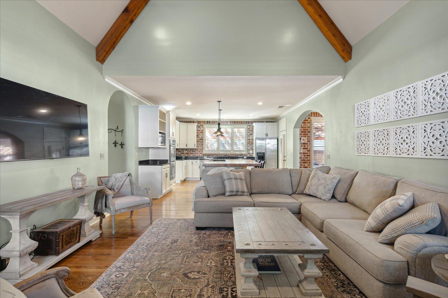 307 Colbert Street West Collierville, TN 38017 - Photo 18 of 34 Living room featuring an inviting chandelier, beamed ceiling, high vaulted ceiling, and hardwood / wood-style flooring