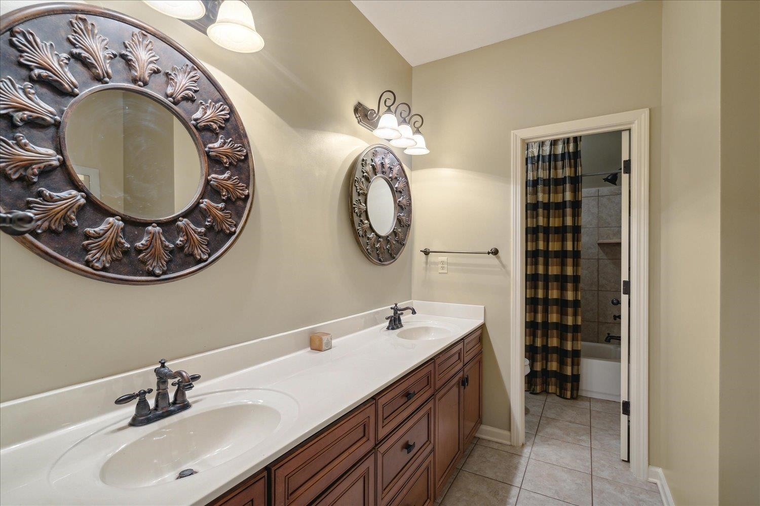 307 Colbert Street West Collierville, TN 38017 - Photo 29 of 34 Bathroom with shower / bath combo with shower curtain, tile patterned floors, and vanity