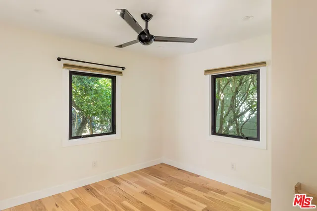 a view of a ceiling fan and window in a room