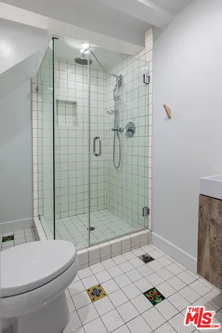 a bathroom with a toilet and a shower