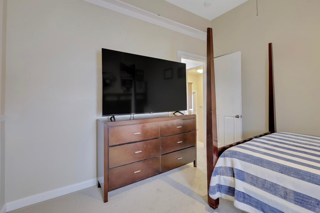 1408 Hazel Street Gridley, CA 95948 - Photo 13 of 60 a bedroom with a bed and a flat screen tv