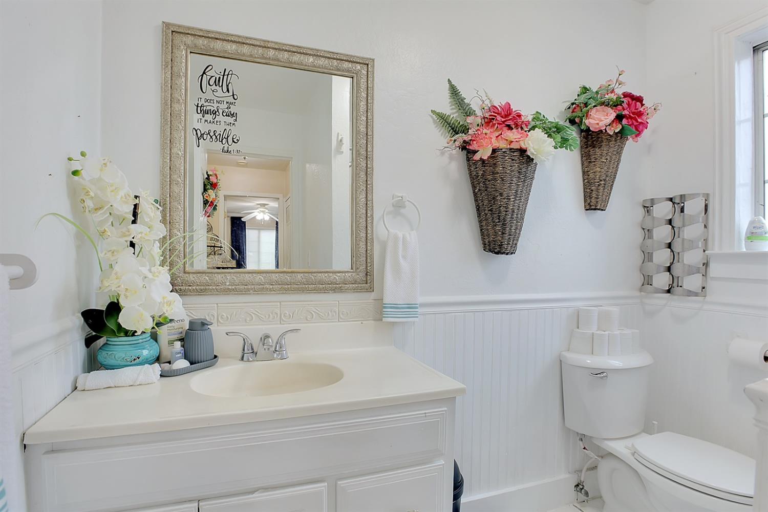 1408 Hazel Street Gridley, CA 95948 - Photo 28 of 60 a bathroom with a sink a toilet and a mirror