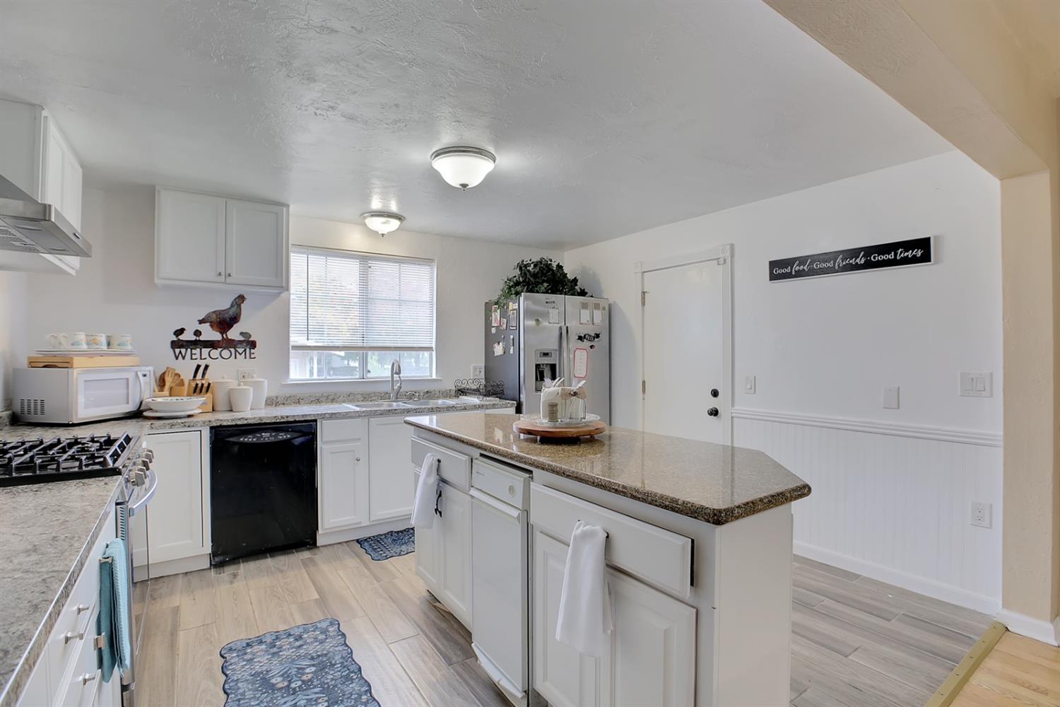 1408 Hazel Street Gridley, CA 95948 - Photo 50 of 60 a kitchen with stainless steel appliances granite countertop a sink stove and refrigerator