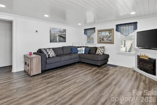 a view of living room kitchen with furniture and wooden floor