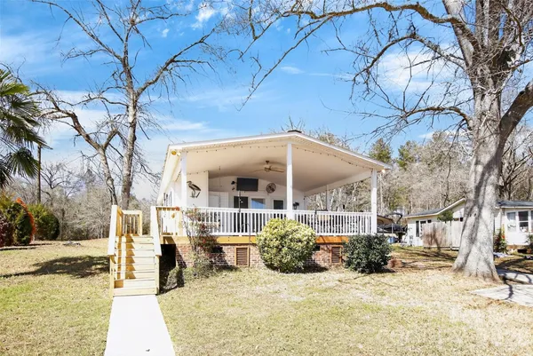 a view of a house with a yard covered with snow