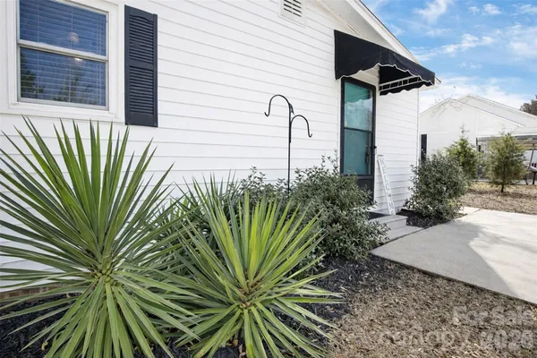 a view of a house with snow on the road