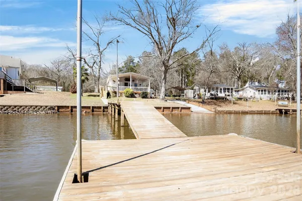 a view of a lake with boats and palm trees