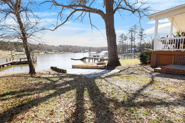 a view of a ocean with a bench and trees